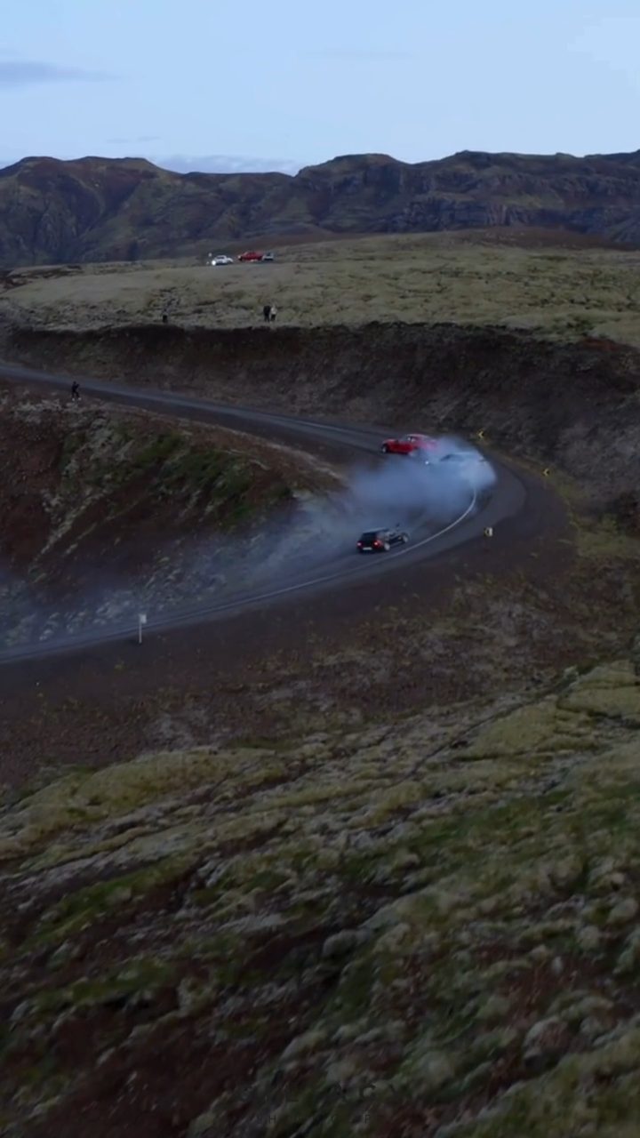 Aerial frame of a road winding through a lava field