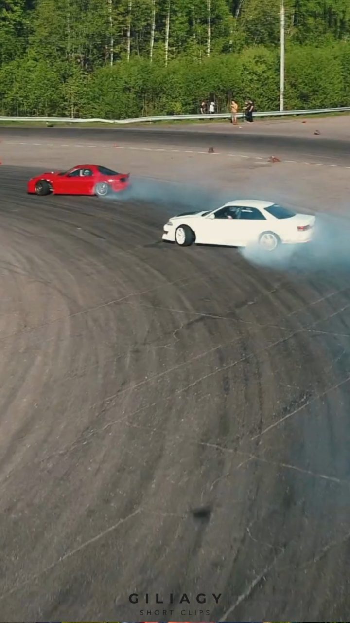 Two cars mid-drift, shot from above